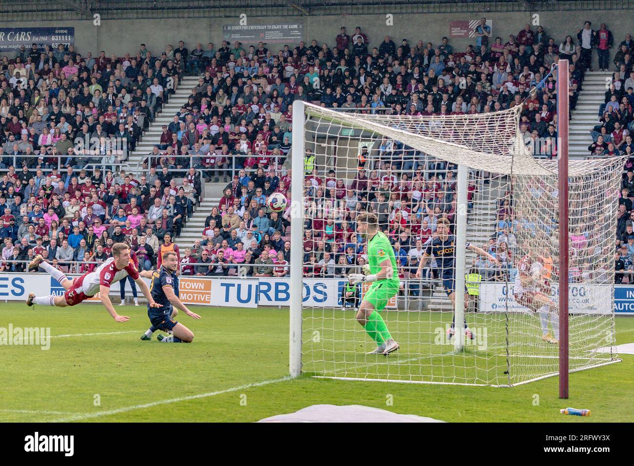Northampton, United Kingdom, April 29, 2023:Max Dyche of Northampton Town scoring his a goal with a diving header in the English Football league. Stock Photo