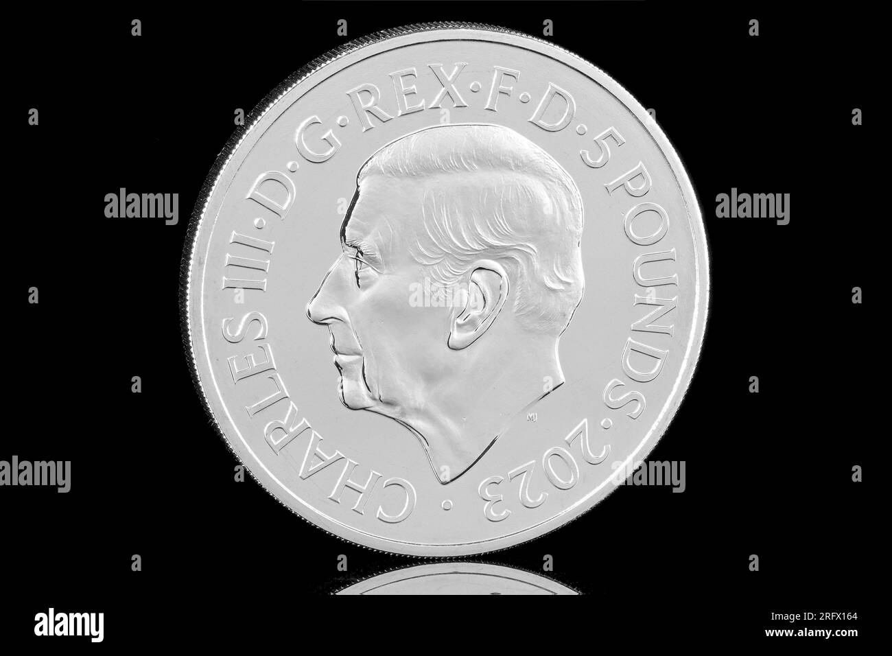 2023 £5 coin featuring the first coin portrait of King Charles III by Martin Jennings. These coins carry various commemorative reverse desings Stock Photo