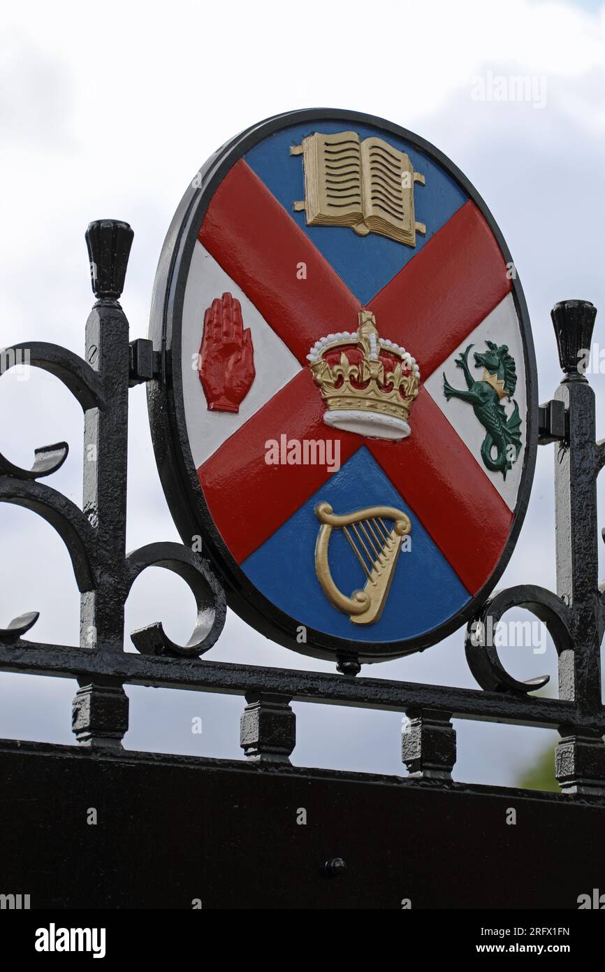 Crest of Queens University Belfast displayed on the entrance gates Stock Photo