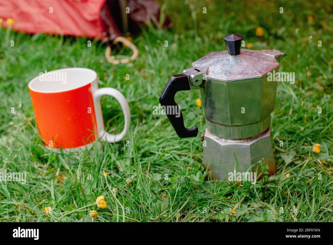 Italian coffee maker with cup on grass Stock Photo