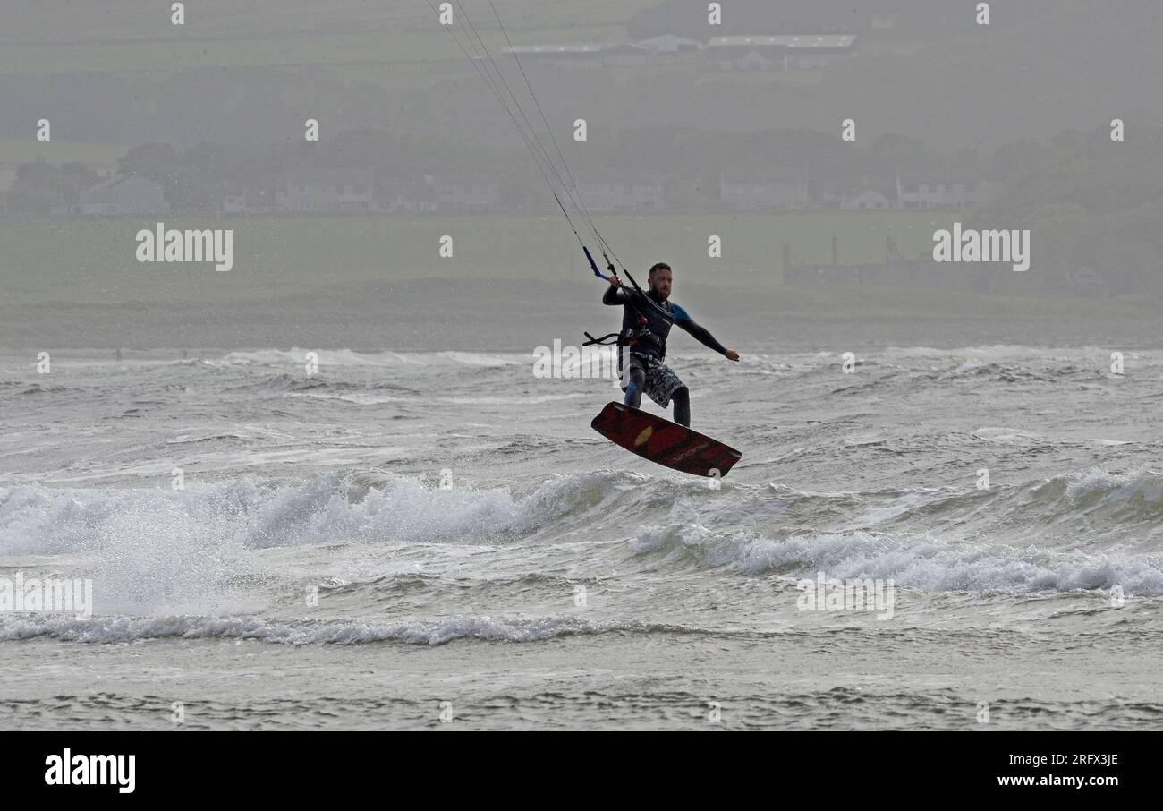 Kite surfing one handed above water Stock Photo