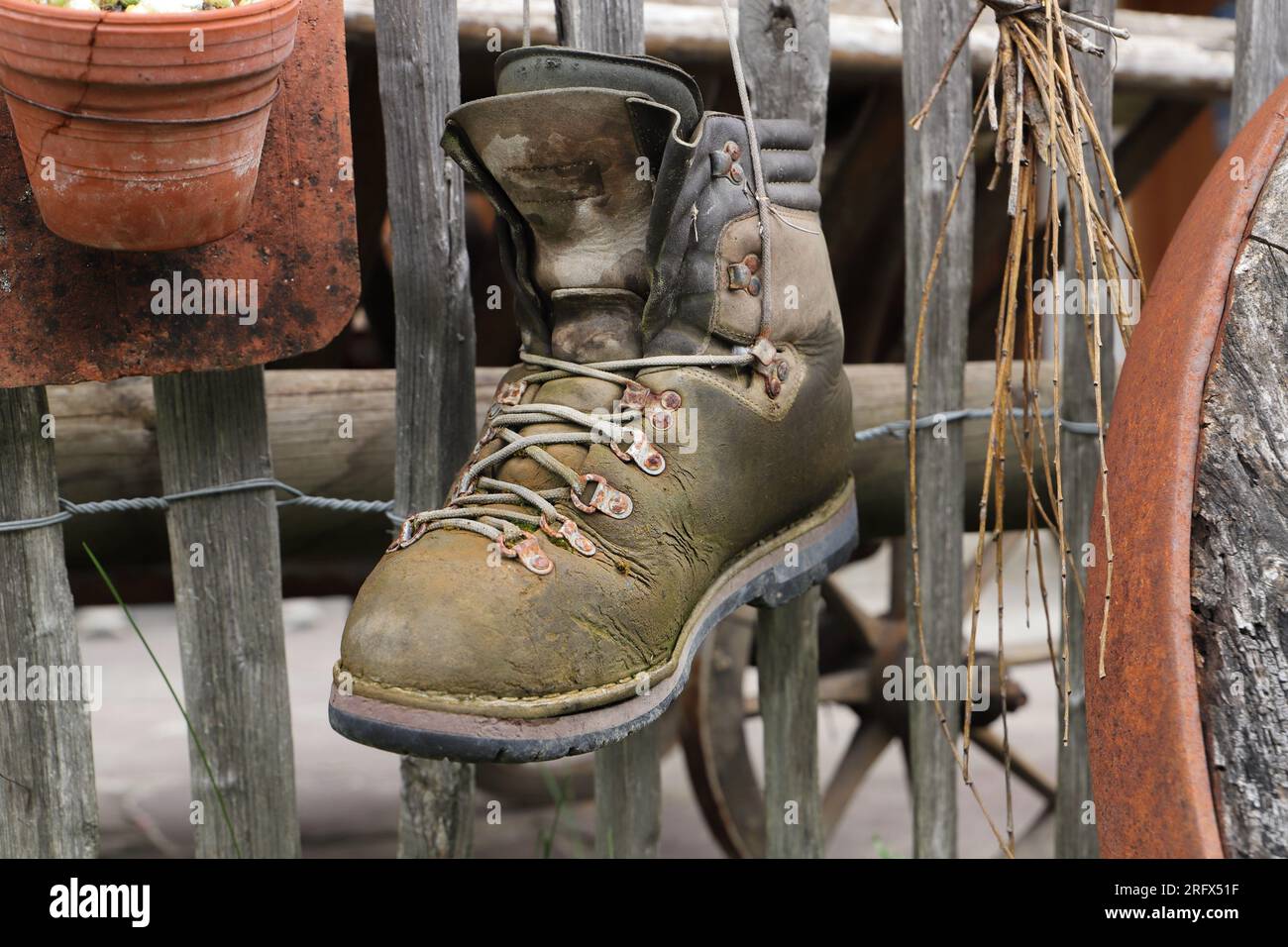 old hiking boots hanging on a fence Stock Photo Alamy