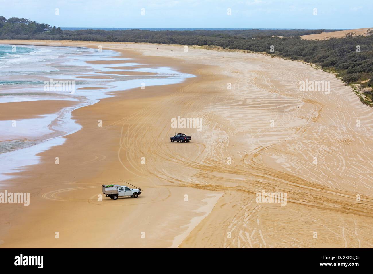 Fraser Island K'gari 75 mile beach sand road and 4WD vehicle driving on the sand,Queensland,Australia Stock Photo