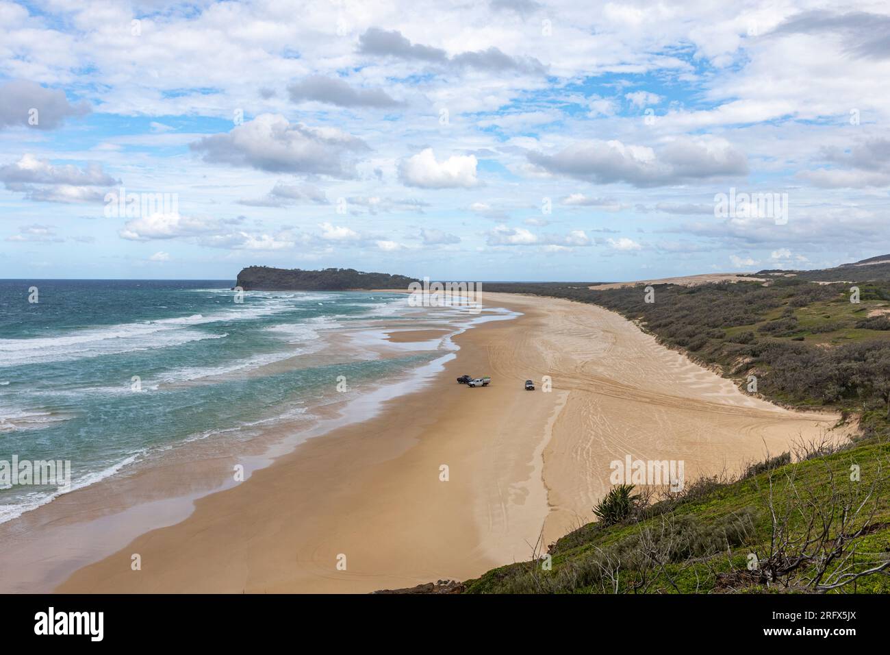 Fraser Island K'gari coastline ocean and 75 mile beach with 4x4 4WD vehicles on the beach,Queensland,Australia Stock Photo