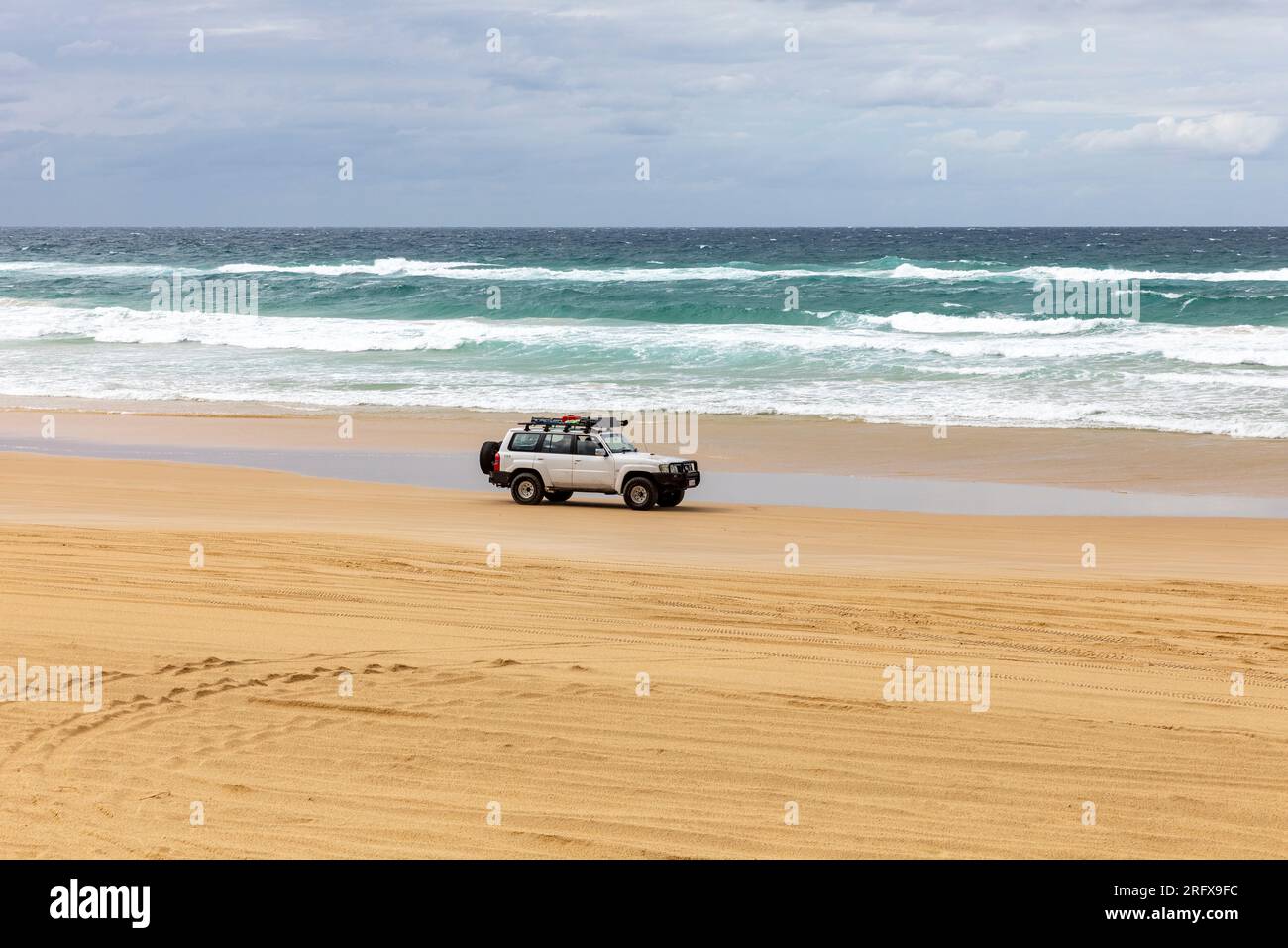 Fraser Island 75 mile beach Nissan Patrol 4x4 vehicle drives along the sand highway, Queensland,Australia Stock Photo