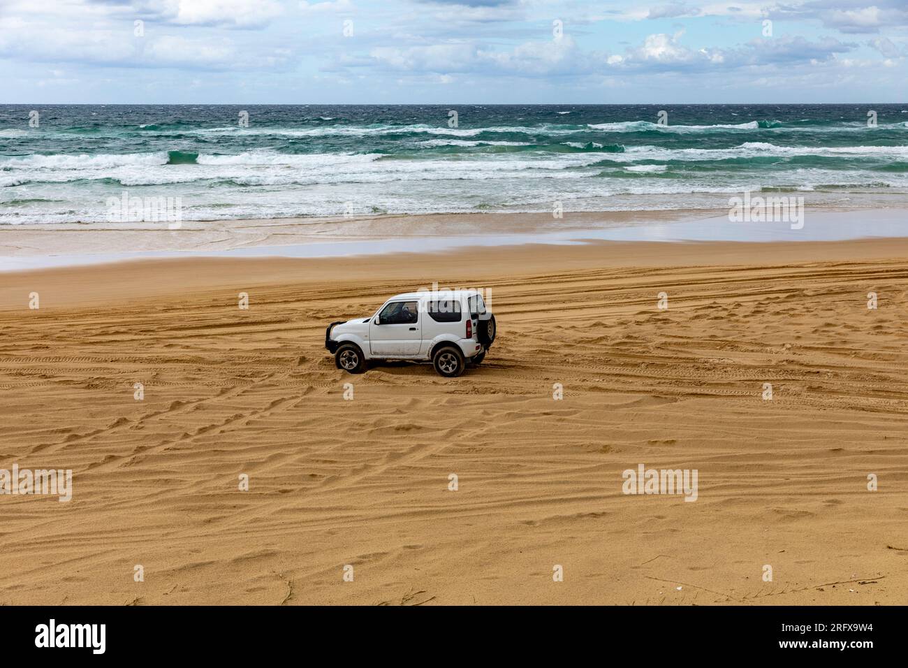 Fraser Island K'gari, four wheel drive 4WD vehicle driving along the legal sand highway 75 mile beach,Queensland,Australia Stock Photo