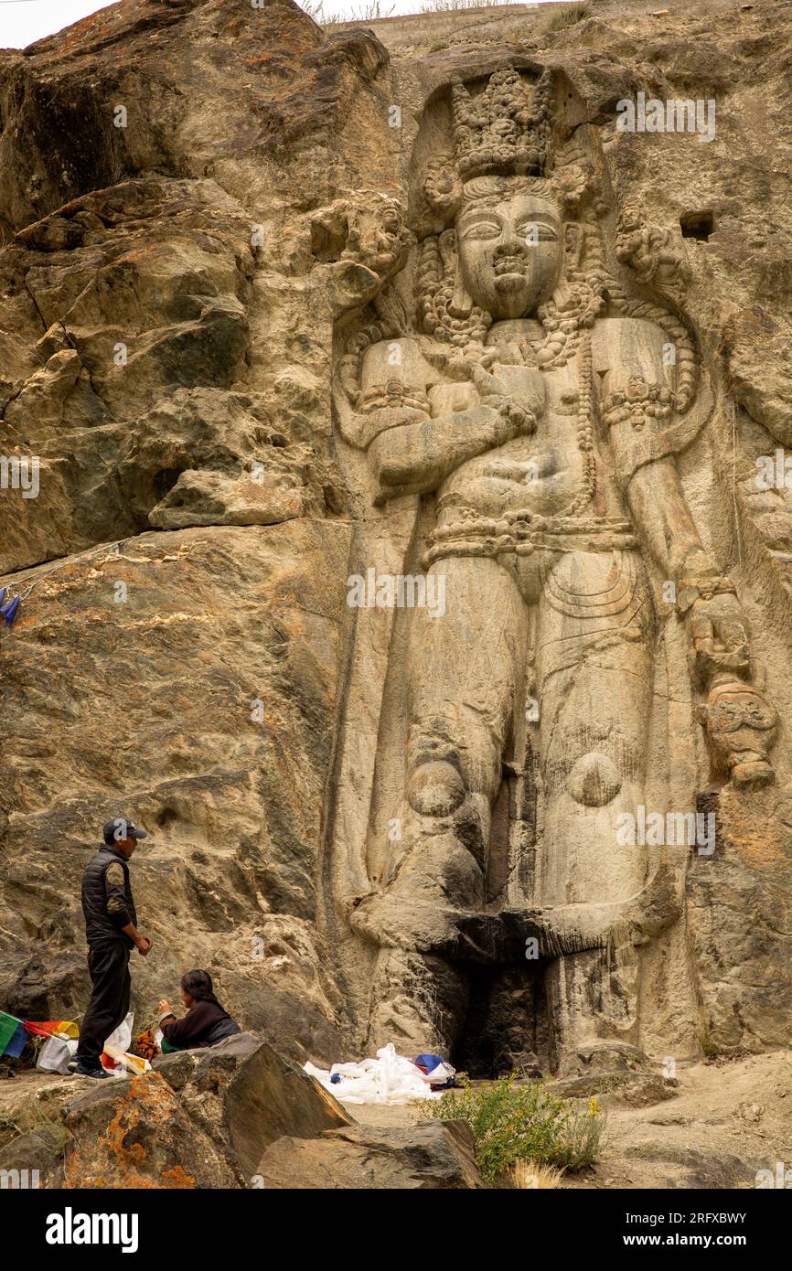 India, Ladakh, Suru Valley, Sankoo, Kartse Khar, pilgrims at Chamba Buddha carved in rock face (C7th-8th) Stock Photo