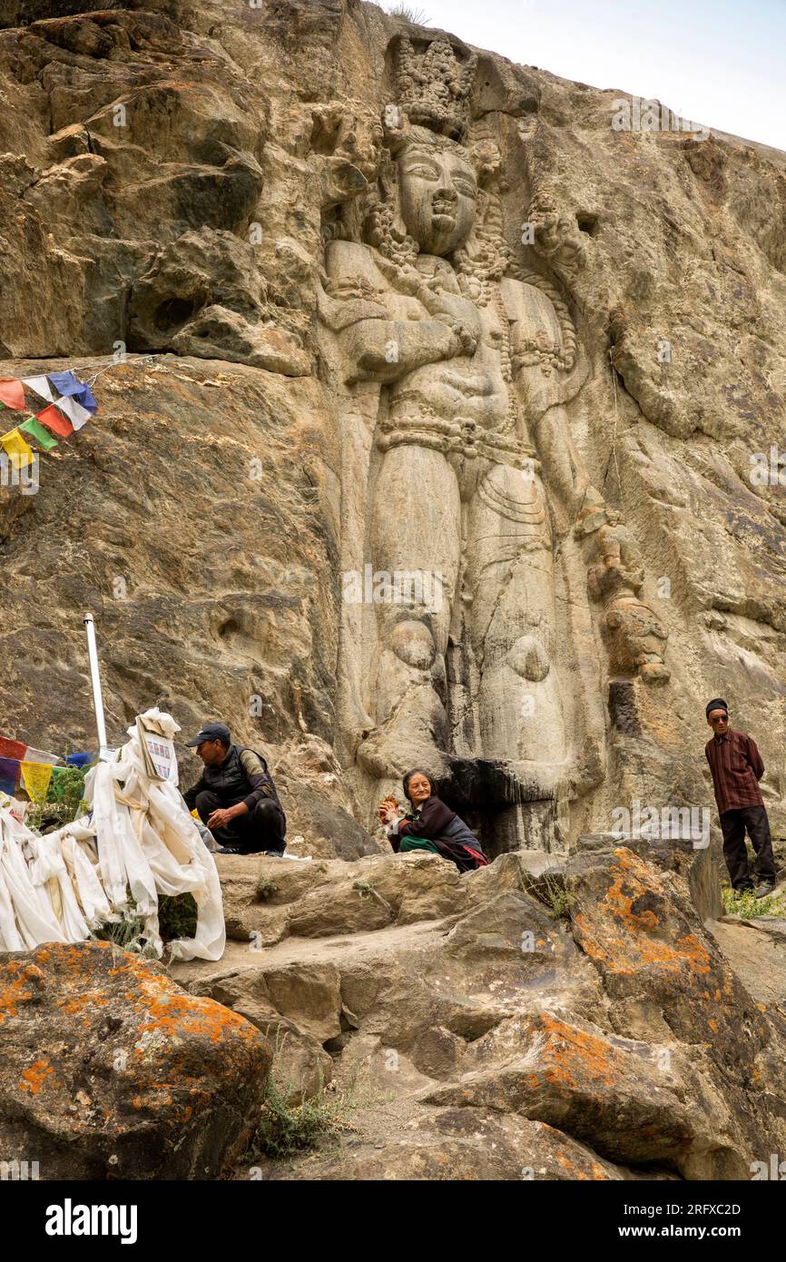 India, Ladakh, Suru Valley, Sankoo, Kartse Khar, pilgrims at Chamba Buddha carved in rock face (C7th-8th) Stock Photo