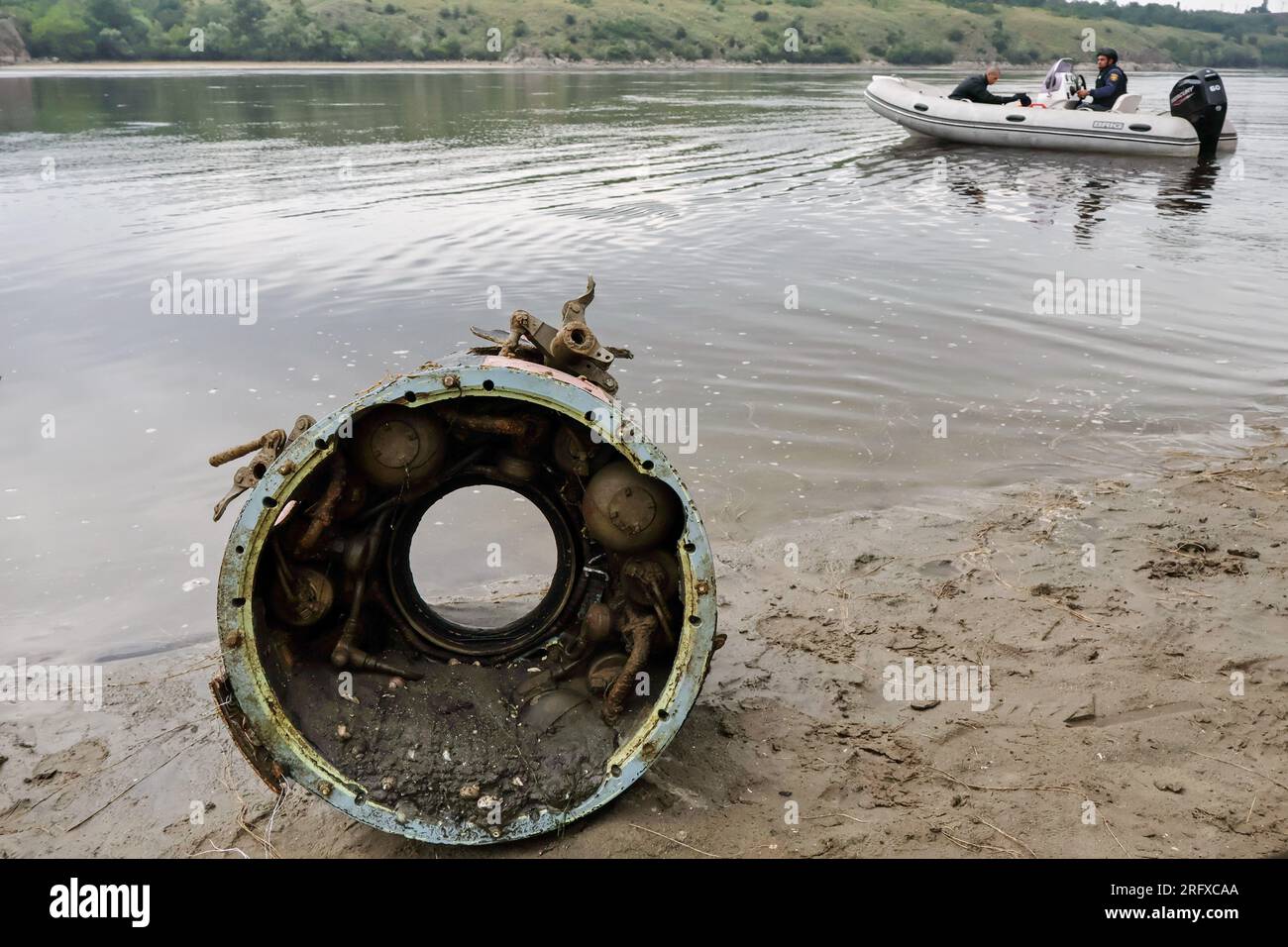 A fragment of a Russian missile seen along the shoreline as Ukrainian sappers sail on a boat during the demining of a Dnipro river in Zaporizhzhia. Ukraine’s international partners will give it over US$244 million for humanitarian mine clearance. Source: Yuliia Svyrydenko, First Deputy Prime Minister and Minister of Economic Development and Trade of Ukraine. Ukraine will also receive individual mine clearance kits, explosive protective suits, quadcopters, and robotic systems for the disposal of ammunition. Stock Photo