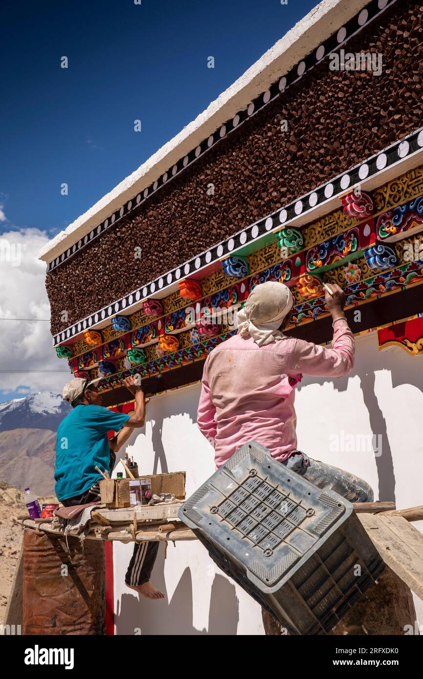India, J&K, Ladakh, men painting traditional Buddhist Wall beside NH1