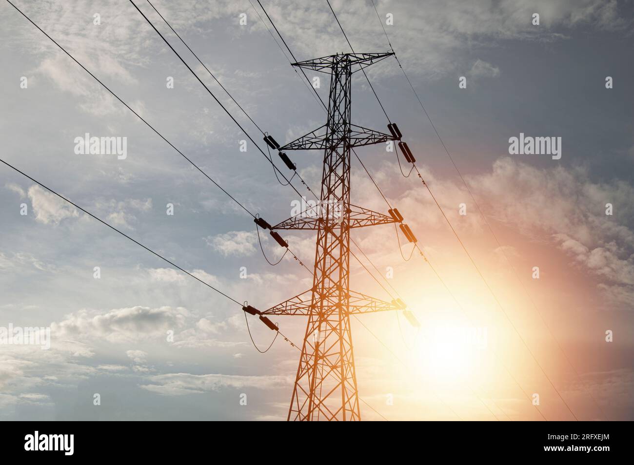 High voltage towers at sunset background. Power lines against the sky ...