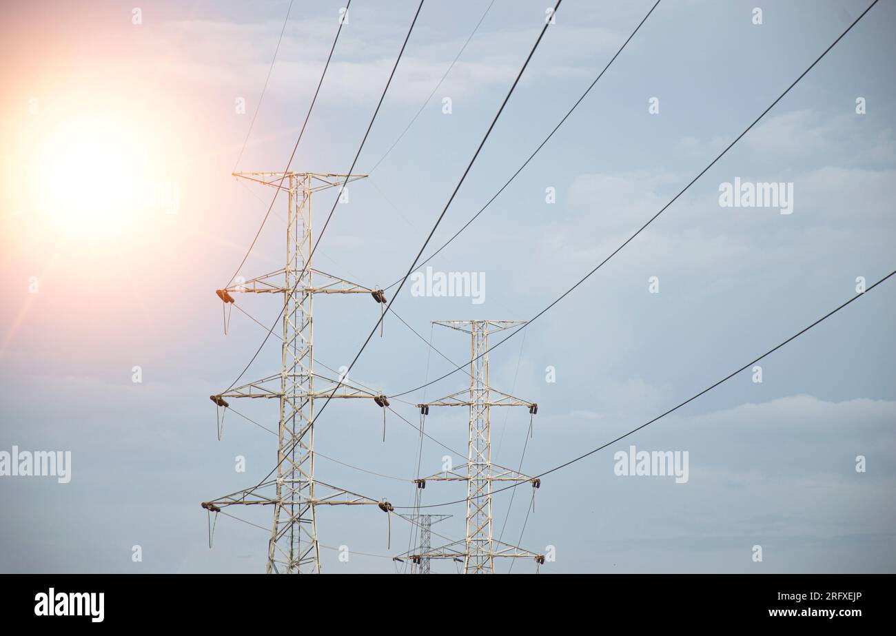 High voltage towers at sunset background. Power lines against the sky ...