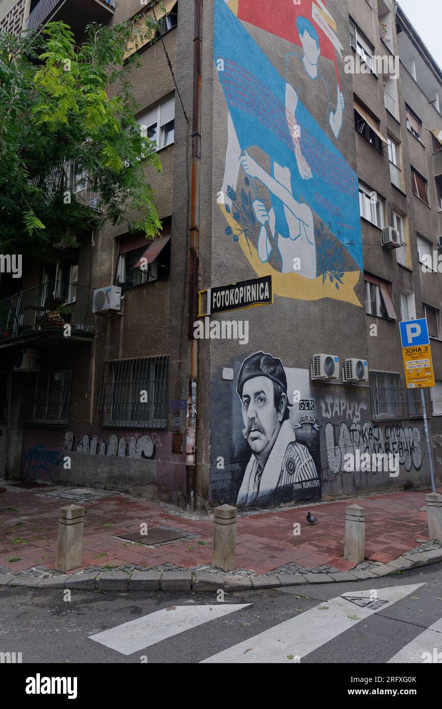 Street Art / Graffiti on a grey drab and depressing apartment building in the capital city of Belgrade, Serbia. August 6, 2023. Stock Photo