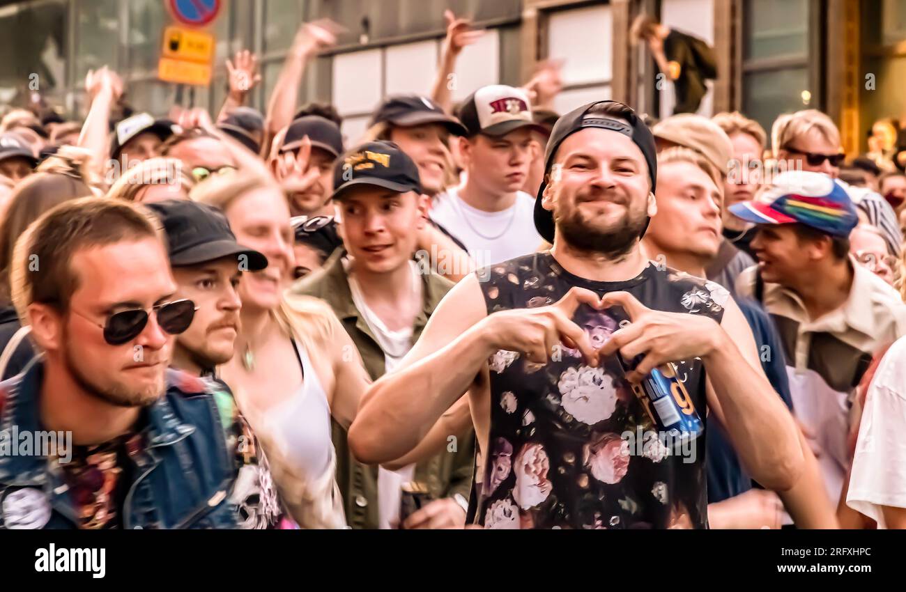 Kallio Block Party 2023 goers partying to Askel & Elere + Friends at the Drum & Bass Finland stage in Vilhonvuorenkatu after sunset. Stock Photo