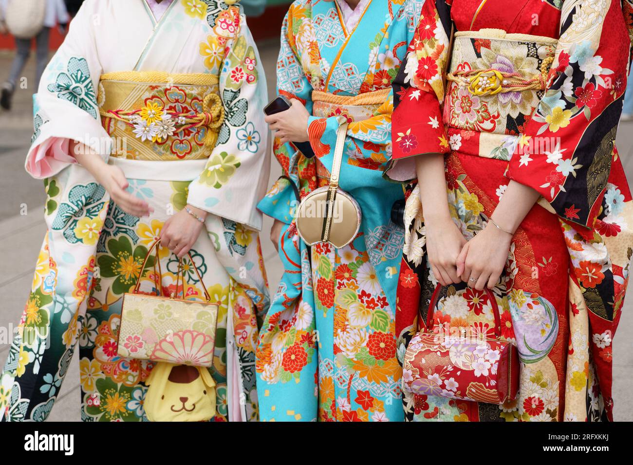 Young girl wearing Japanese kimono standing in front of Sensoji Temple