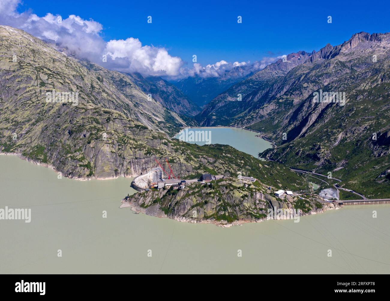 View over the Grimselsee reservoir to the Grimsel Hospice, Räterichsbodensee behind, Grimsel area, Bernese Oberland, Canton of Bern, Switzerland Stock Photo