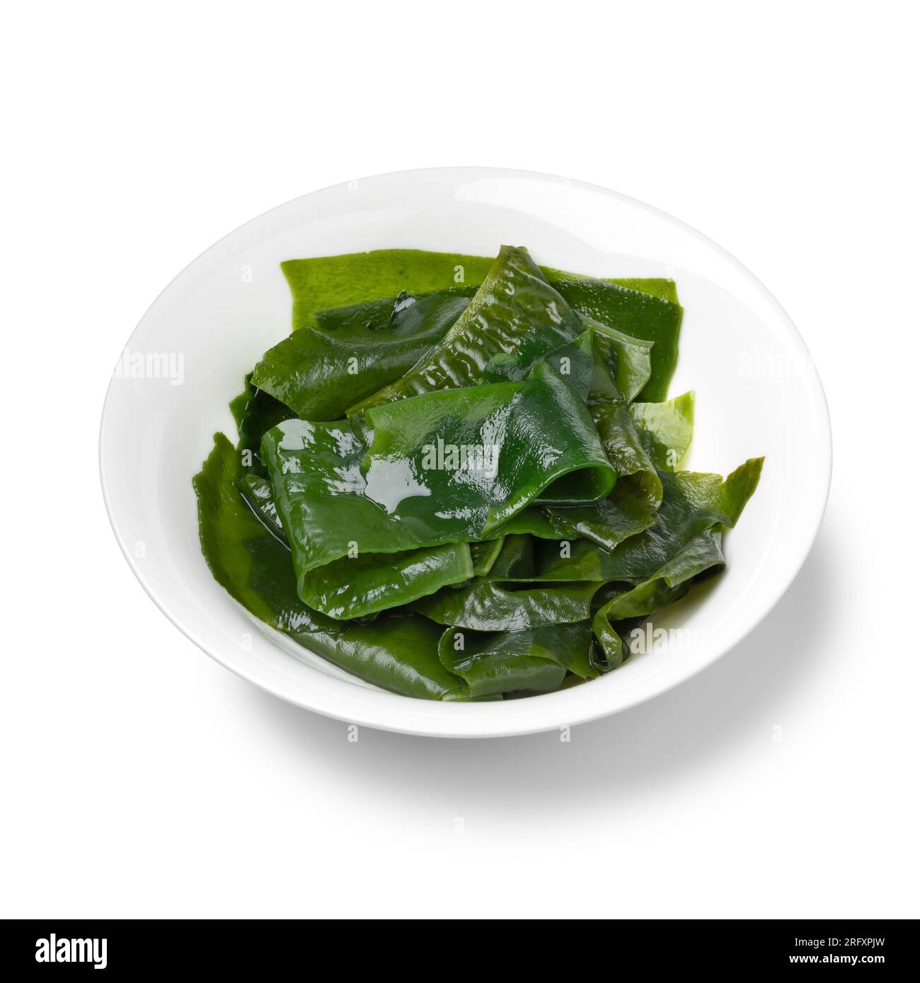 Bowl with soaked wakame close up isolated on white background Stock Photo