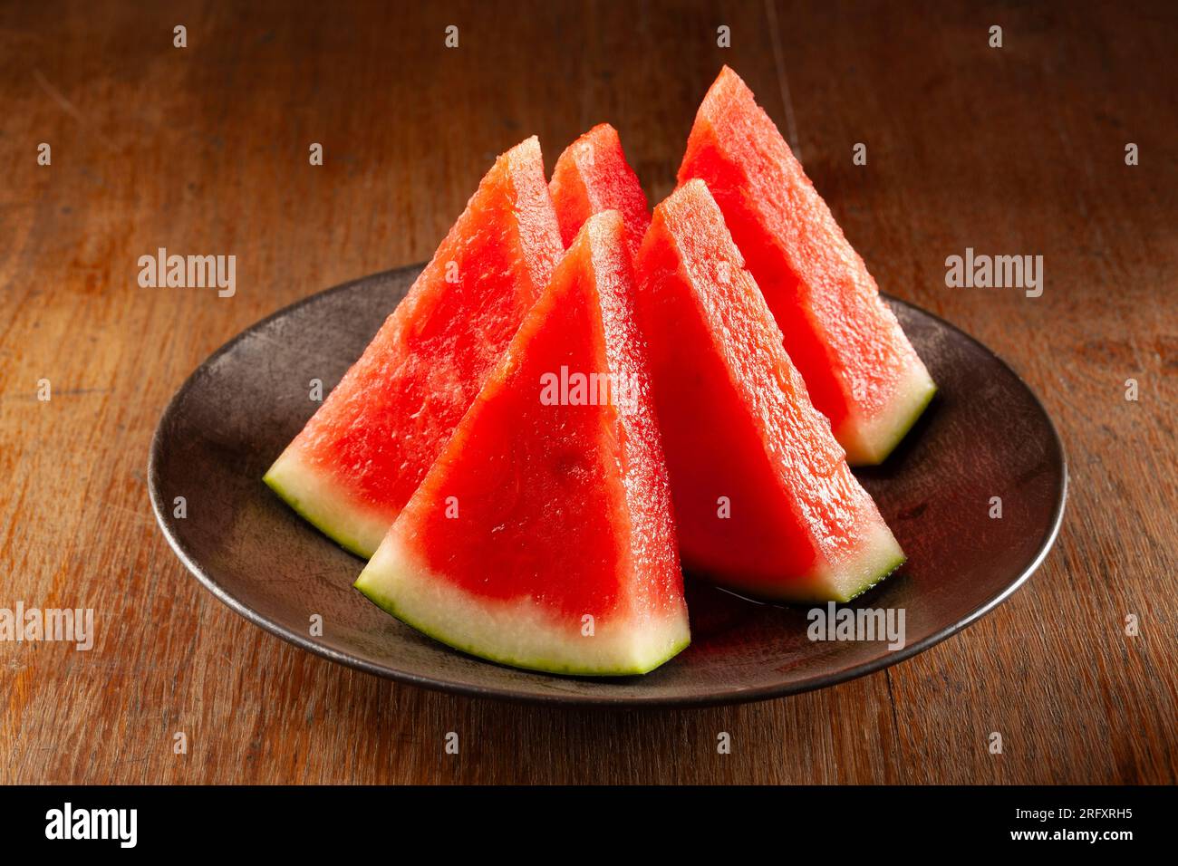 watermelon slices on black plate Stock Photo