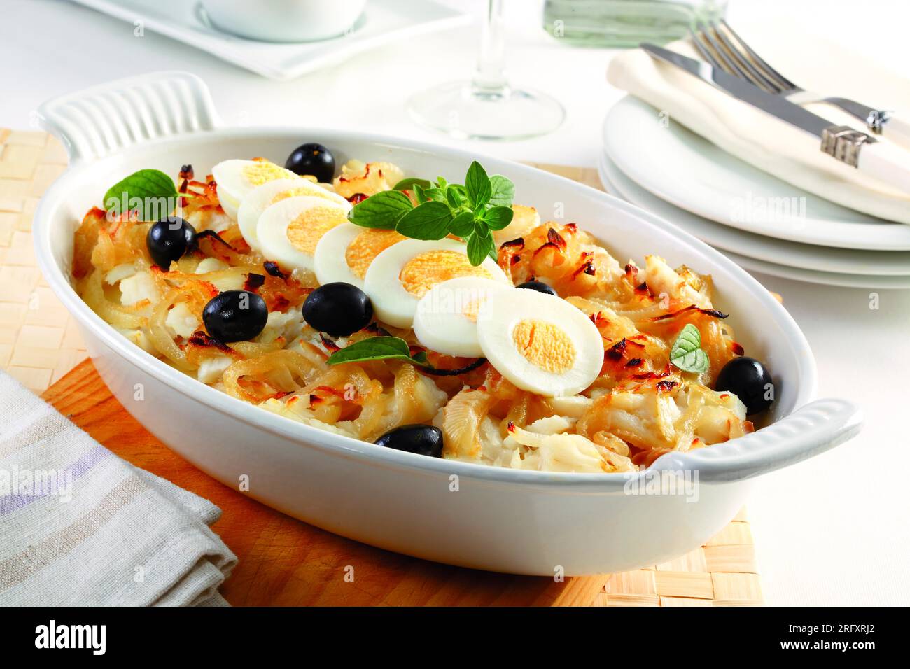 Oval Cod Baked cod with onion, black olives, boiled eggs and oregano. In an oval ...