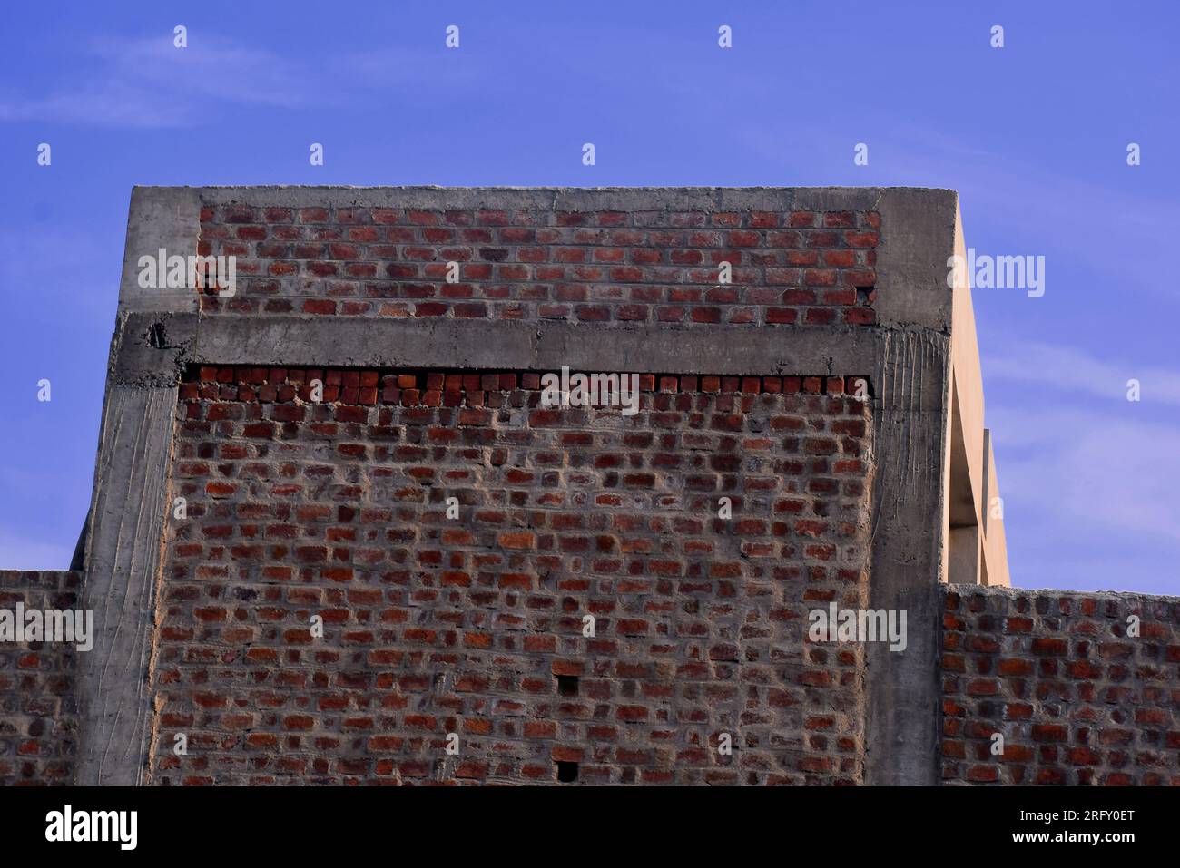 Top of an old brick building against a blue sky, brick top Stock Photo ...