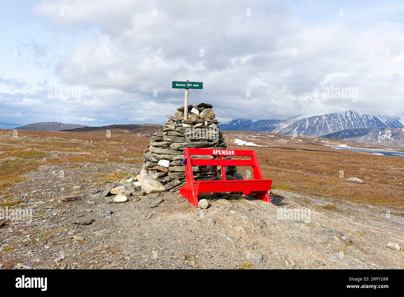 Summit of Barheia with a red bench and a cairn. Scenic view of the surrounding mountains and the fjord. Svensby, Lyngen Alps, Lyngen, Northern Norway Stock Photo