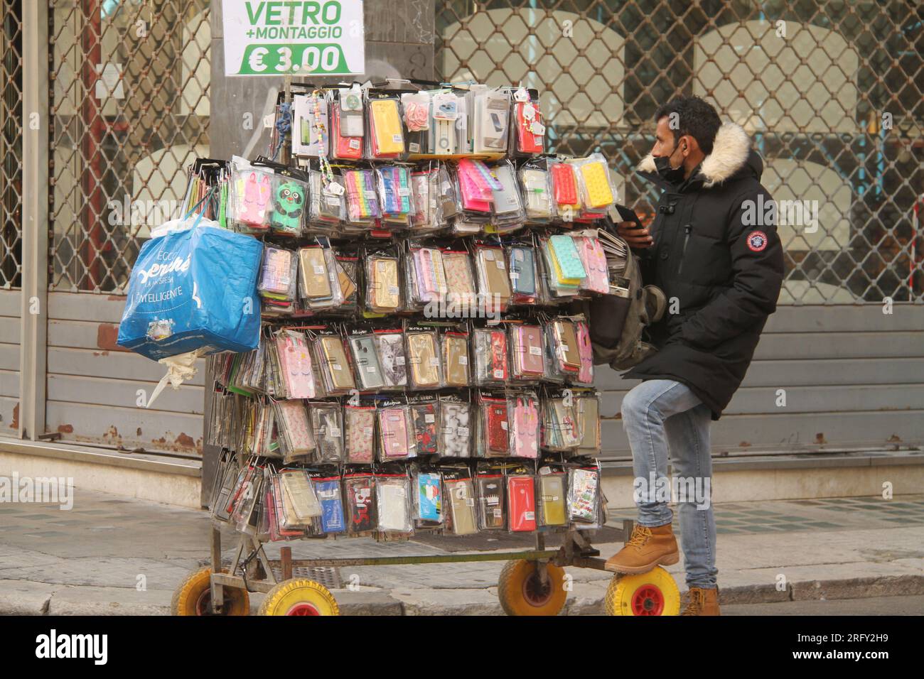 Street vendor selling phone cases on a street in Lecce, Italy Stock Photo
