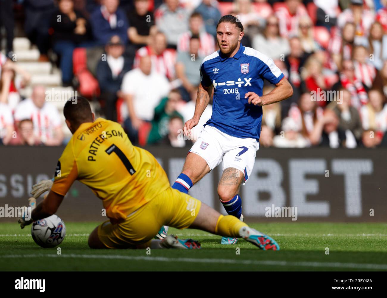 Sunderland goalkeeper Anthony Patterson (left) saves at the feet of ...