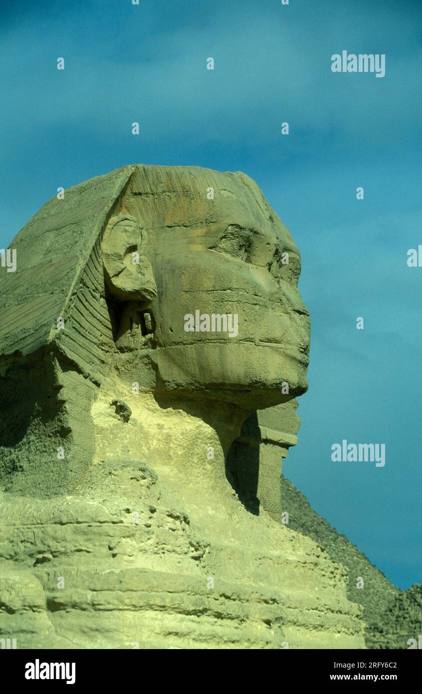 the monument of Sphinx in front of pyramids of giza near the city of ...