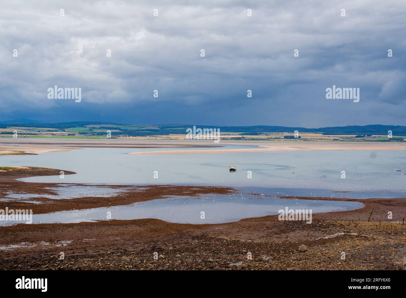 Storm approaching causeway to Lindisfarne, Holy Island, during high tide Stock Photo