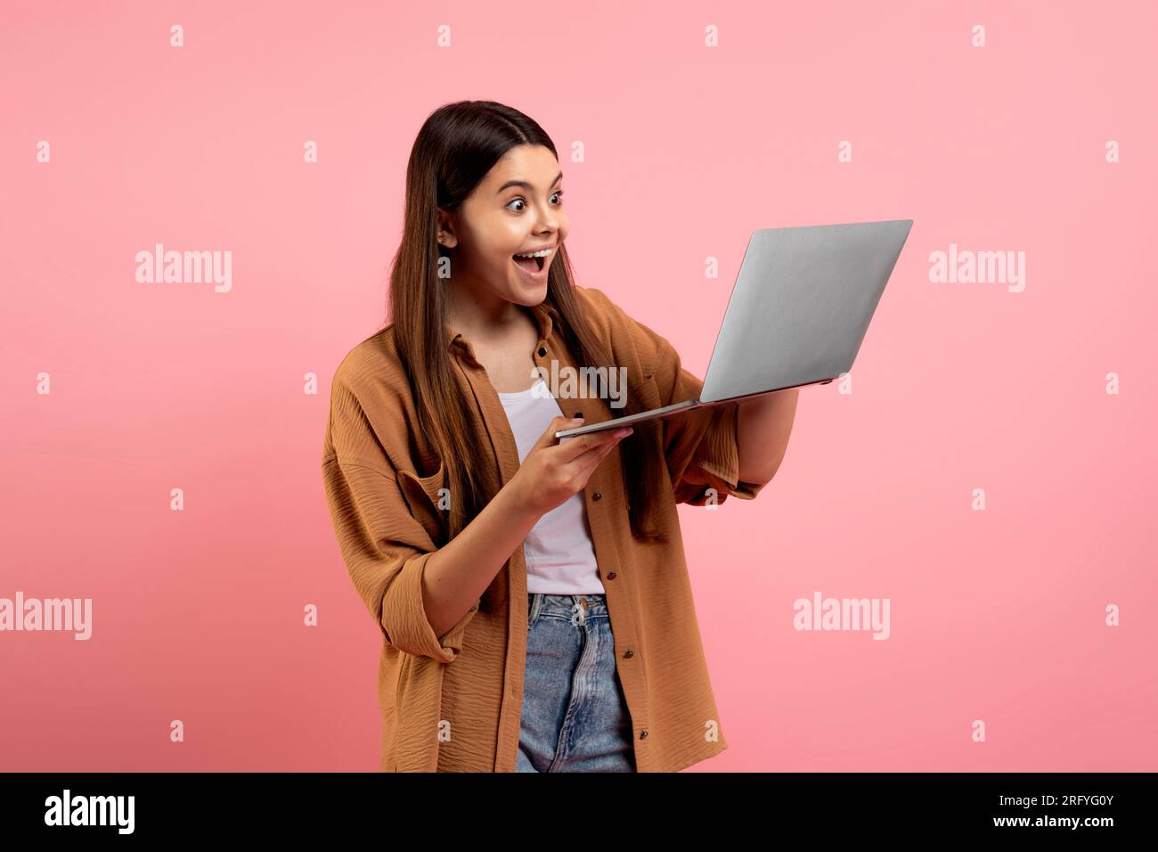 Teen surprised looking computer screen hi-res stock photography and ...