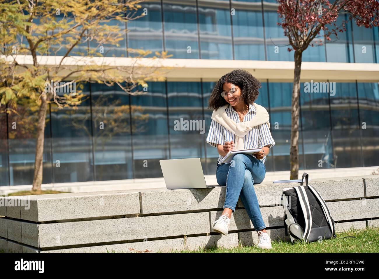 Happy African American girl student elearning online outdoors using ...
