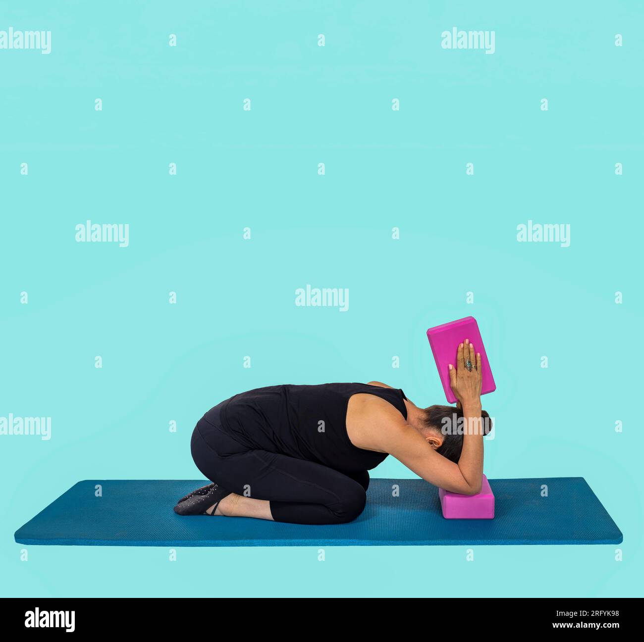 Trauma releasing exercises, senior citizen woman in her sixties, performing body strength and recovery exercises on a mat Stock Photo