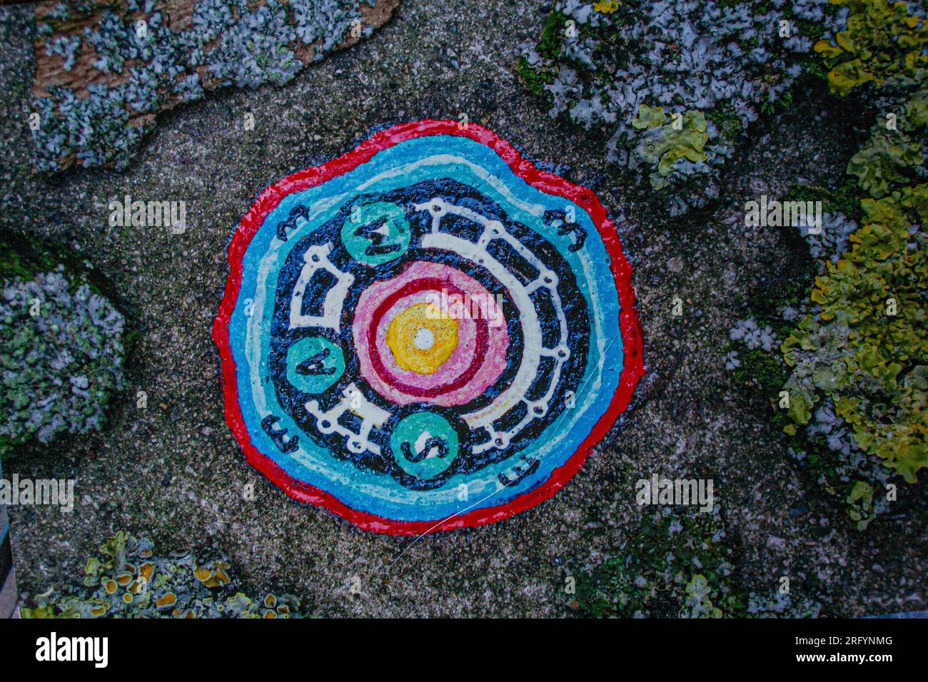 London, UK. Tiny work of art painted on a discarded piece of chewing gum by Ben Wilson 'Chewing Gum Man' on the pavement Stock Photo