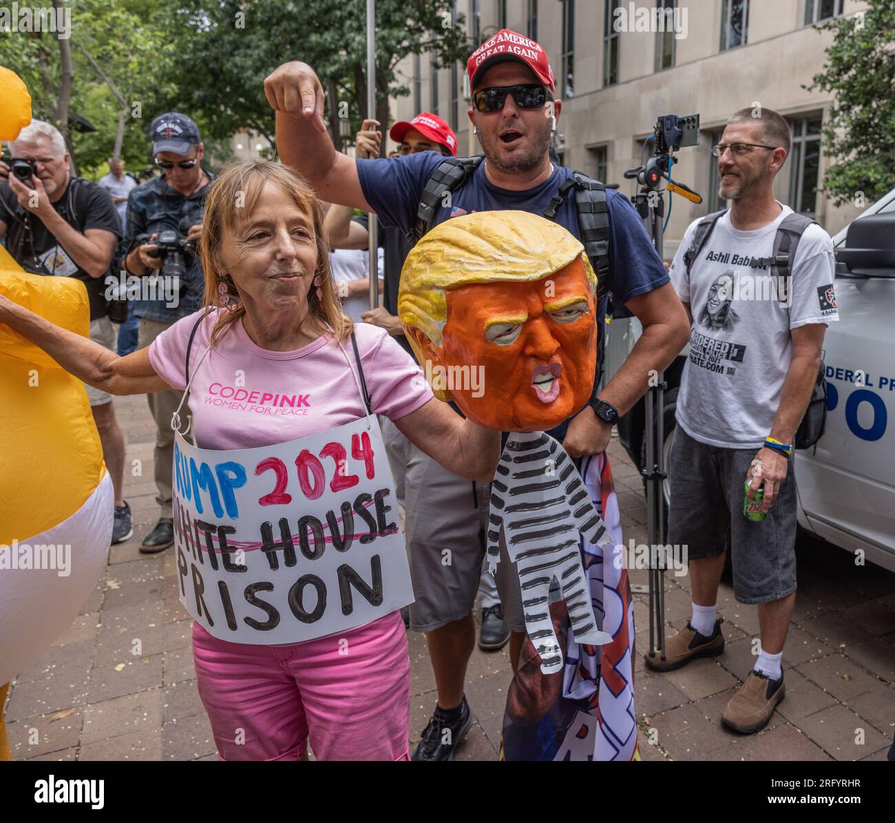 WASHINGTON, D.C. — August 3, 2023: Demonstrators and others are seen near a federal courthouse on the day of an arraignment hearing for Donald Trump. Stock Photo