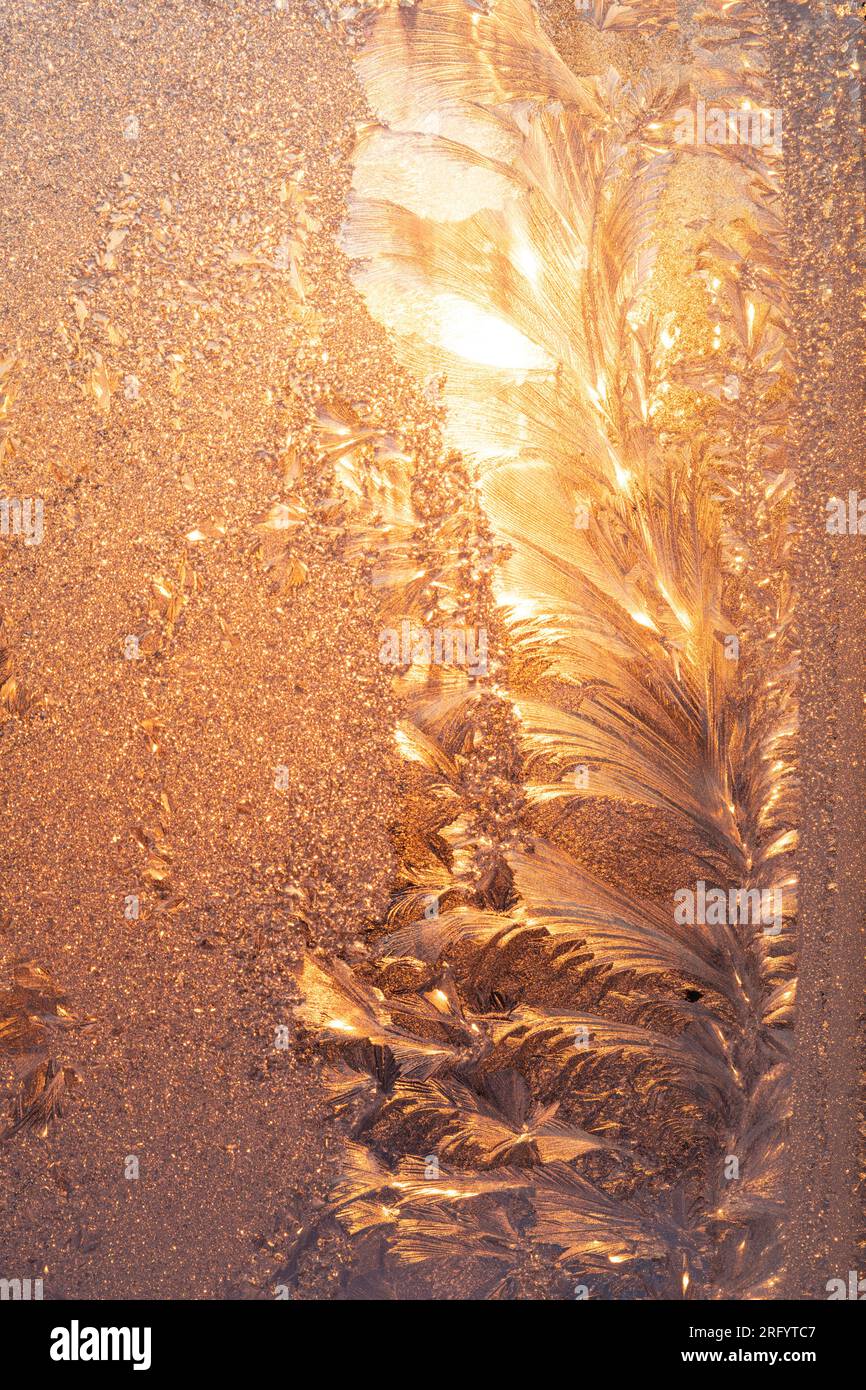 Fire and Ice, Sun shining through ice covered window in Winter Stock Photo