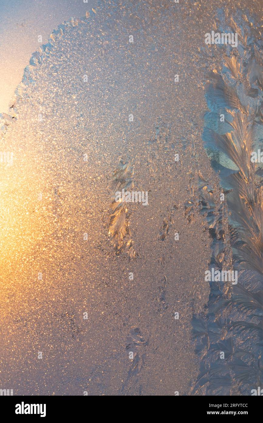 Fire and Ice, Sun shining through ice covered window in Winter Stock Photo