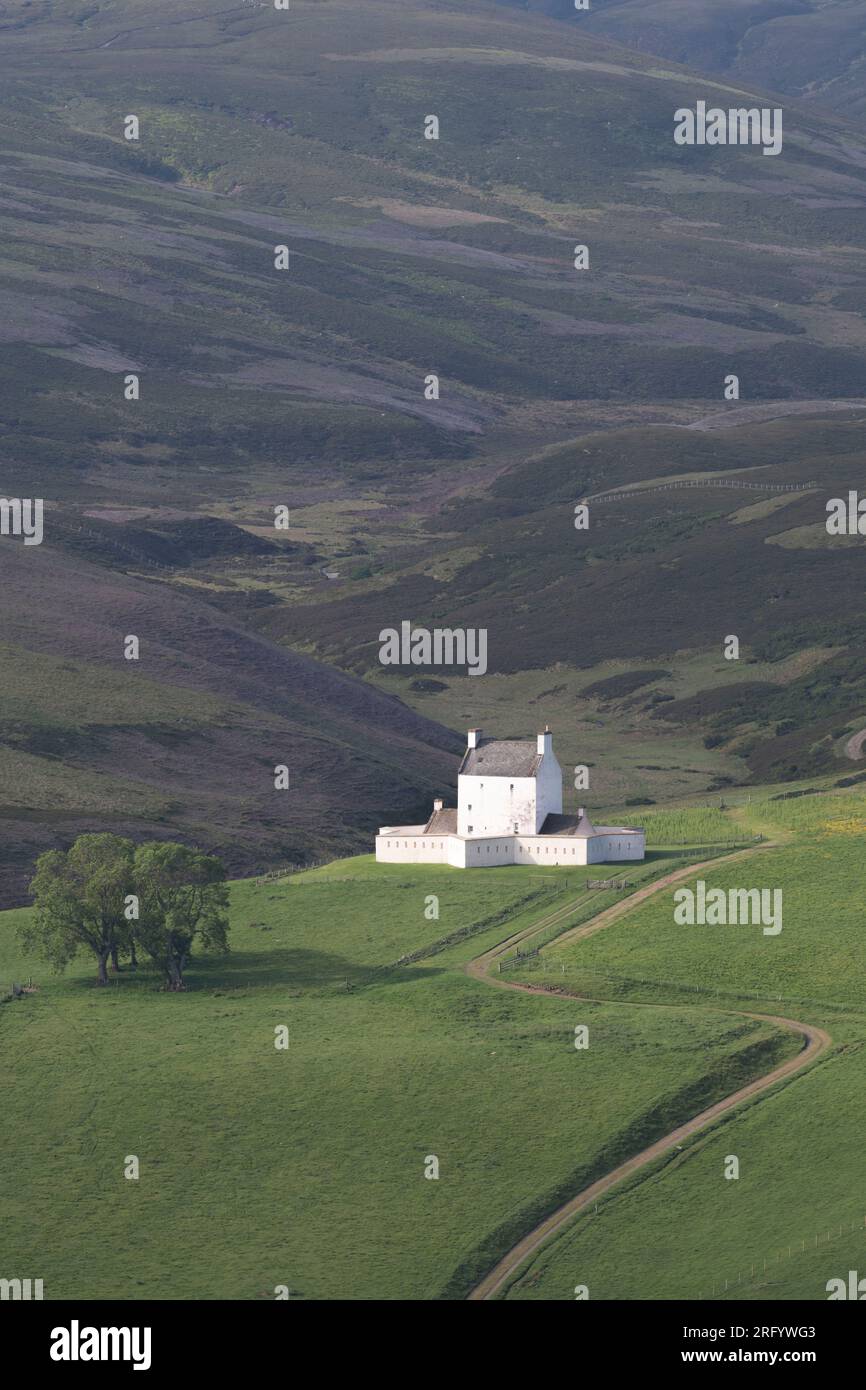 Perched on a Sunlit Mountainside in the Cairngorms National Park, Corgarff Castle in Aberdeenshire is Surrounded by Moorland Stock Photo