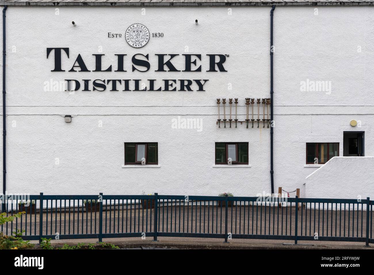 The Talisker Distillery Name on the Side of the Talisker Whisky Distillery & Visitor Centre at Carbost on the Isle of Skye Stock Photo