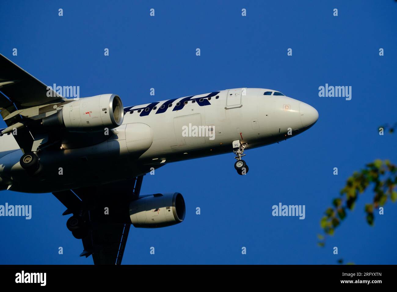 Helsinki / Finland - AUGUST 5, 2023:Airbus A320, operated by Finnair, approaching the airport during sunset. Stock Photo