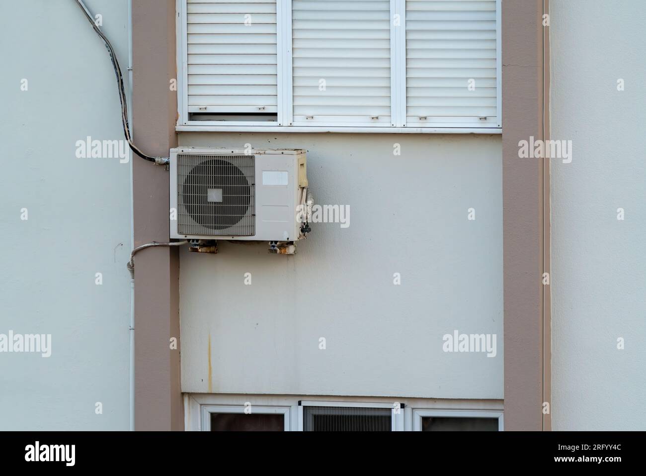 Split air conditioner outdoor unit hung outside the building Stock