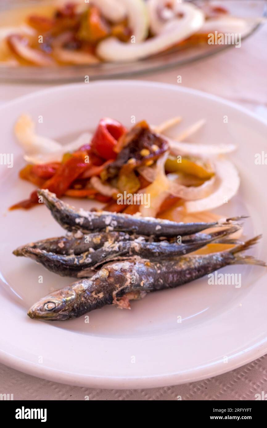 Grilled sardines and pepper salad in a Malaga restaurant Stock Photo