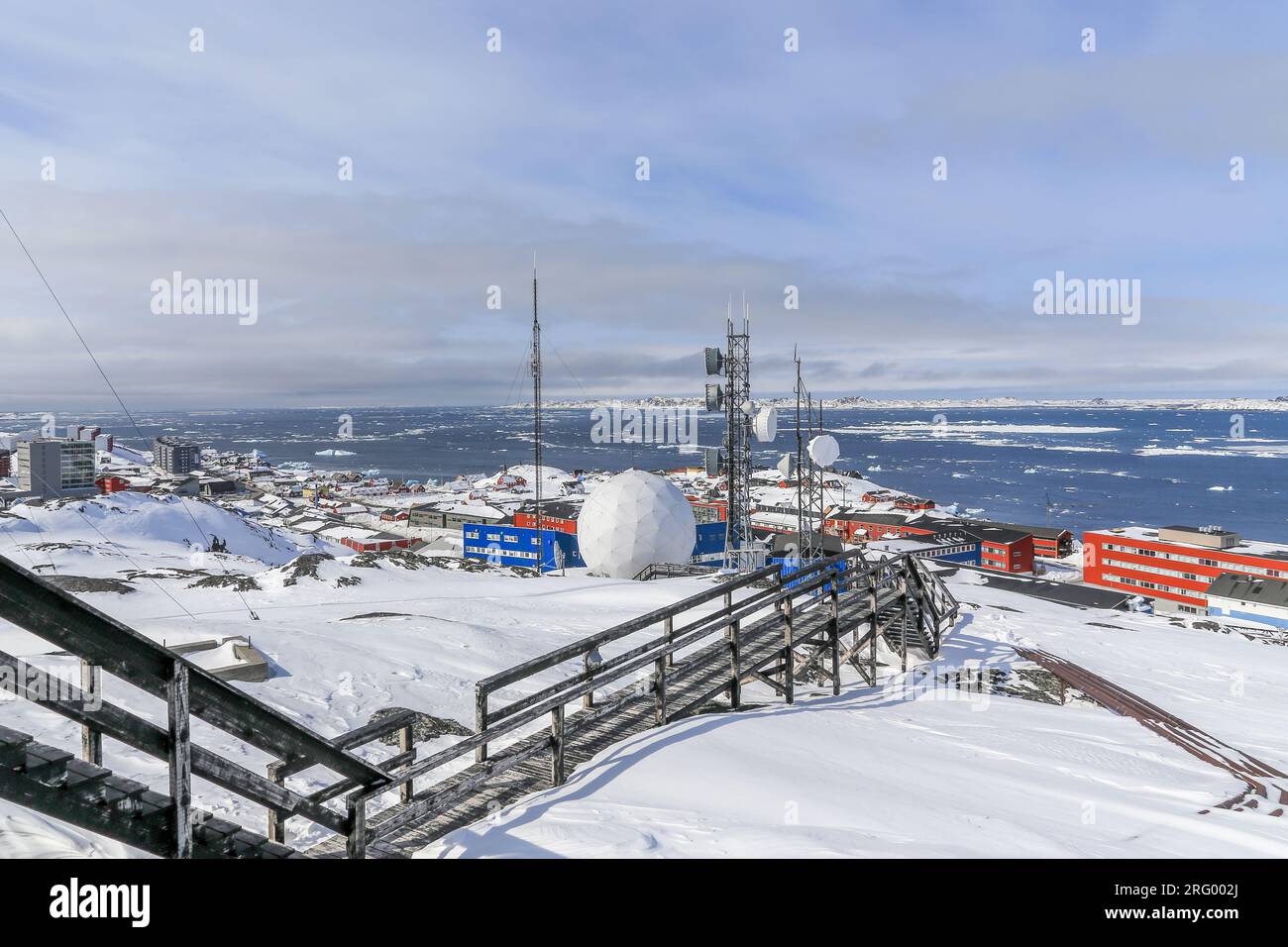 Stairs to the arctic station covered in snow and Nuuk city fjord view, Greenland Stock Photo