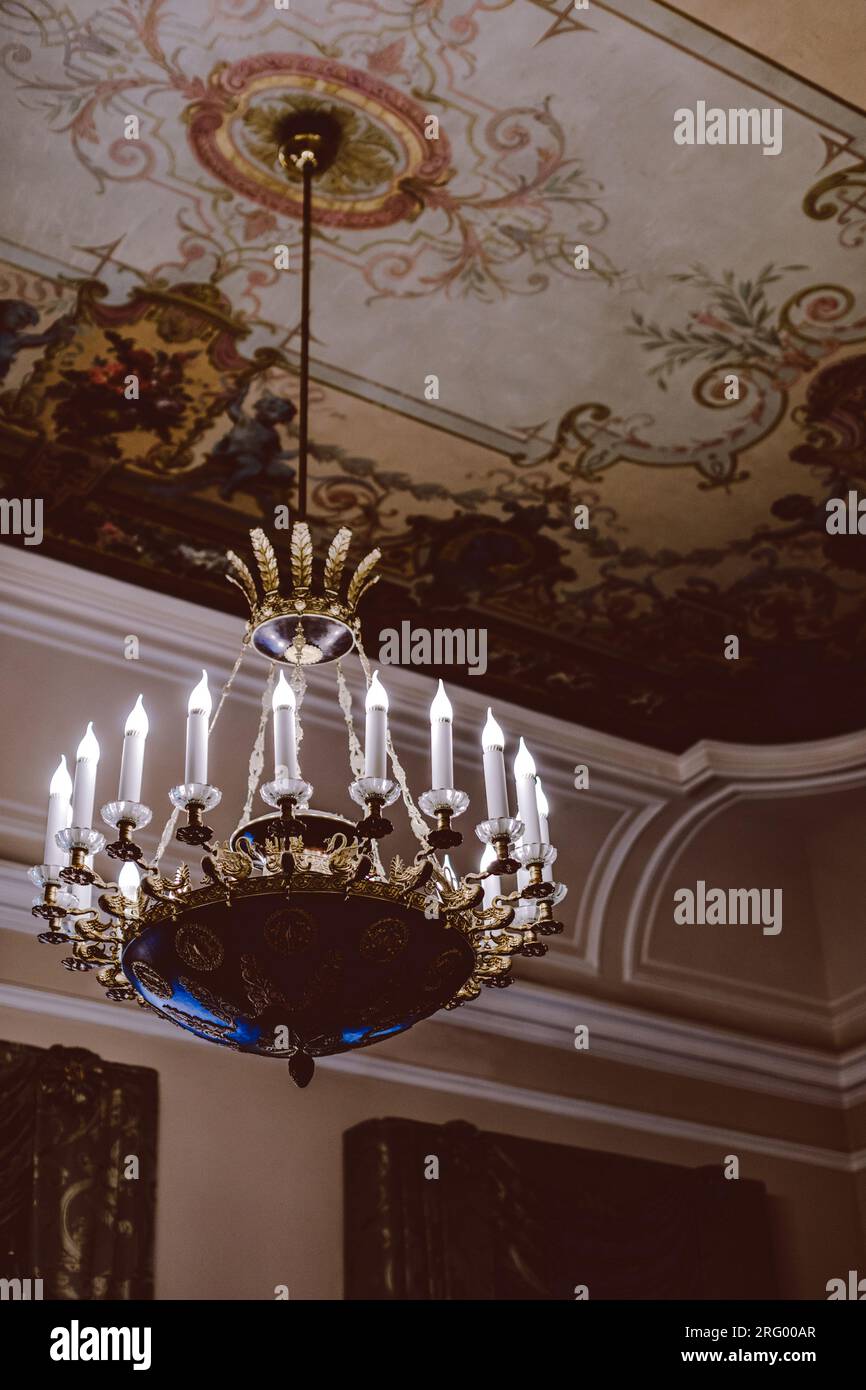 Royal crystal historical chandelier with candles. Baroque architecture