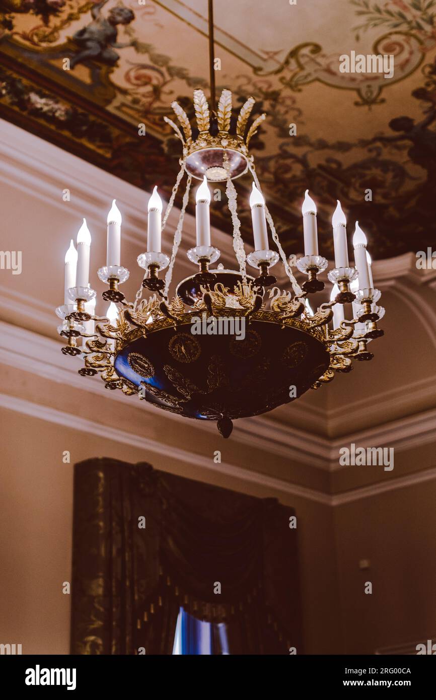 Royal crystal historical chandelier with candles. Baroque architecture