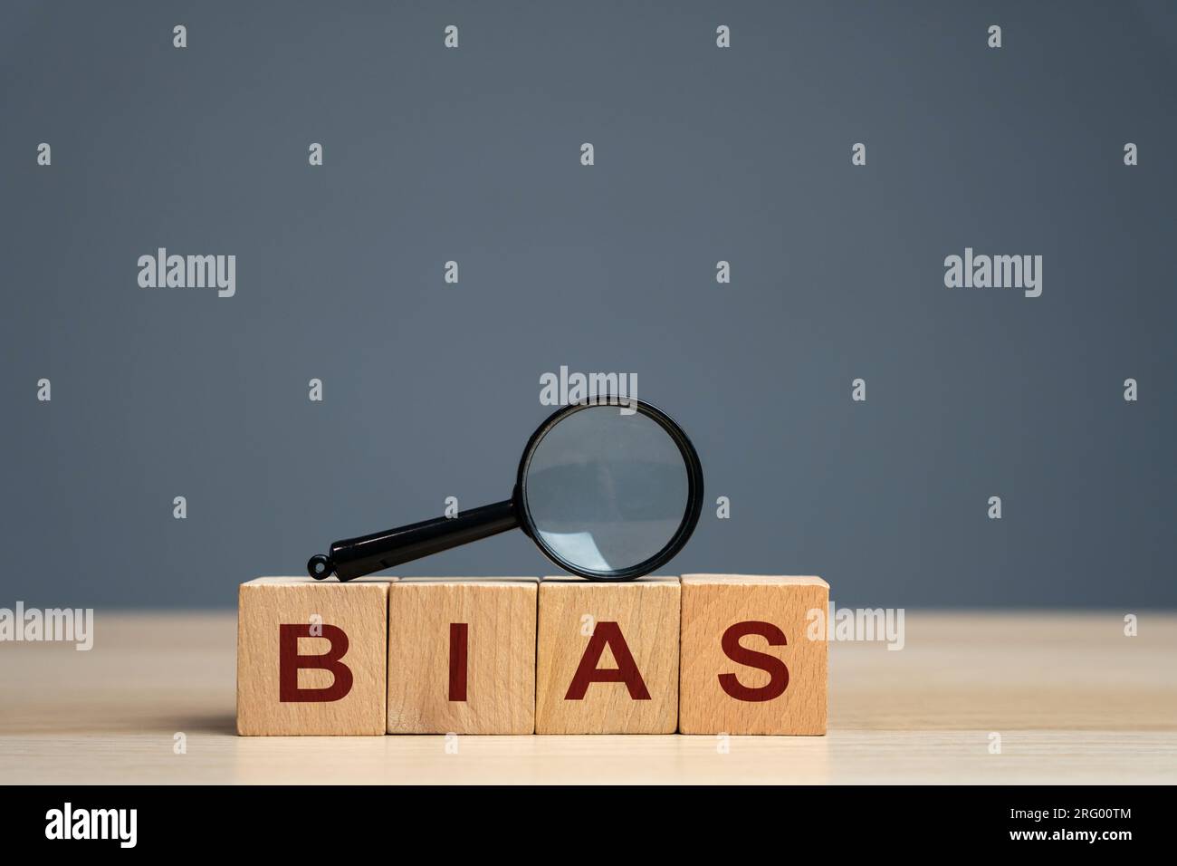 Bias word on a wooden blocks. Prejudice. Personal opinions. Preconception. Concept of facts and biases. Magnifying glass Stock Photo