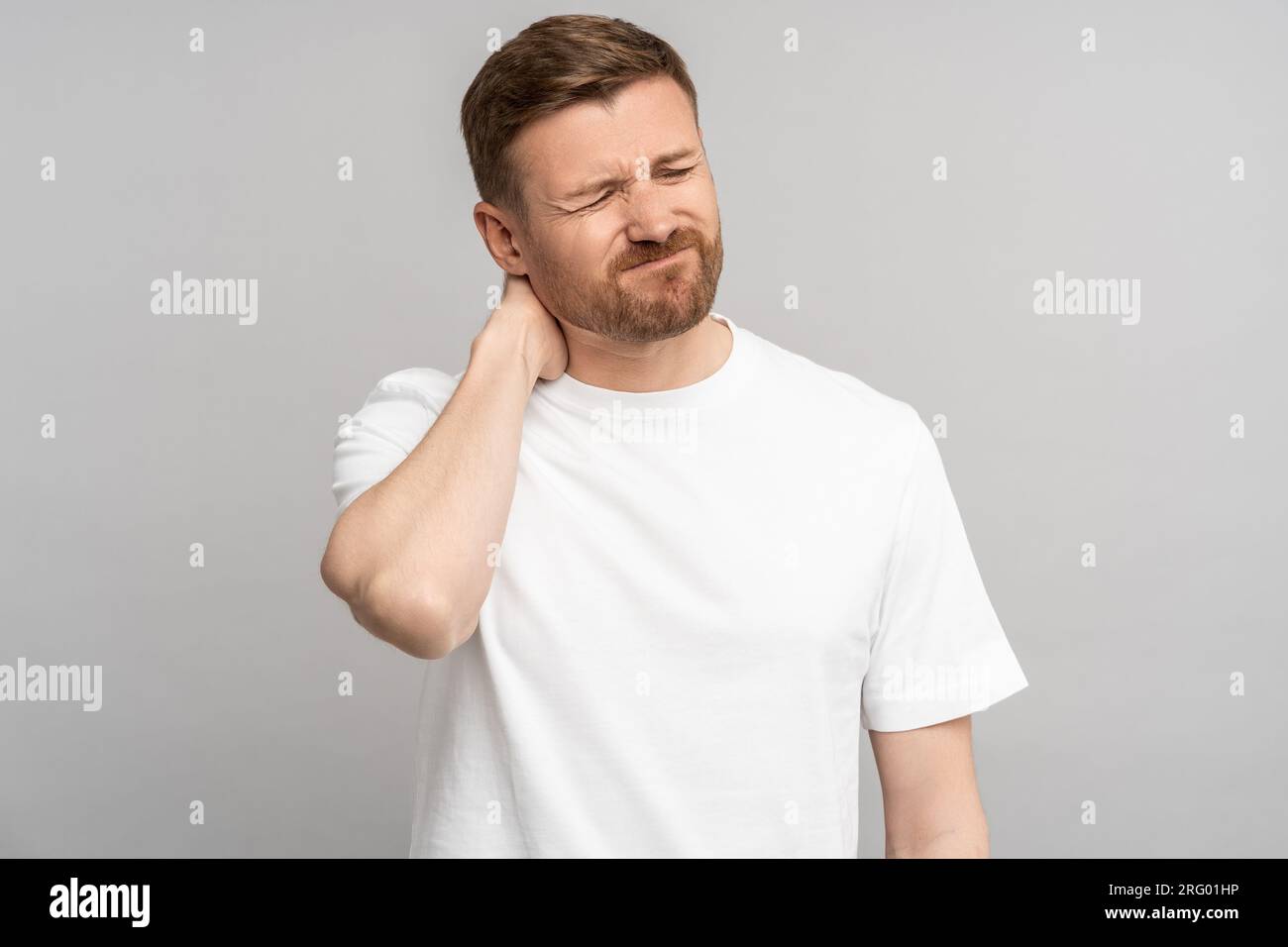 Neck pain. Suffering ache from herniated disc exhausted young man touch