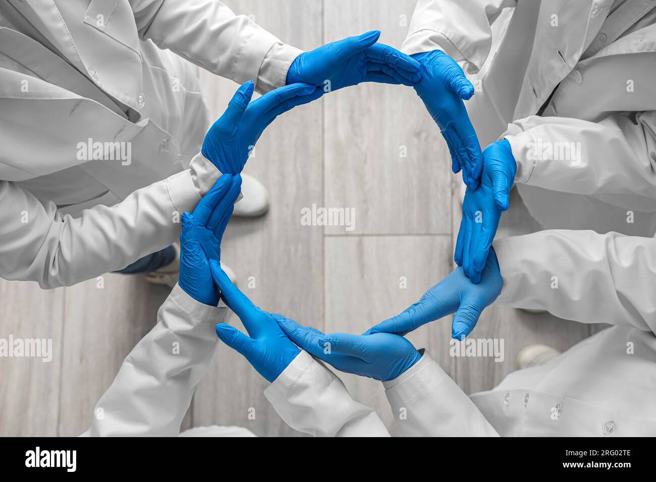 Doctors in medical gloves making circle at clinic, top view Stock Photo ...
