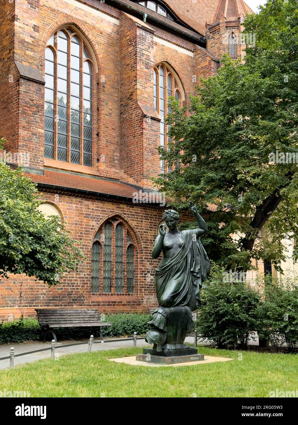 BERLIN, GERMANY - JULY 22, 2023: A classical statue in the garden of Nikolaikirche, also known as Nikolaikirche, also known as St. Nicholas Church in Stock Photo