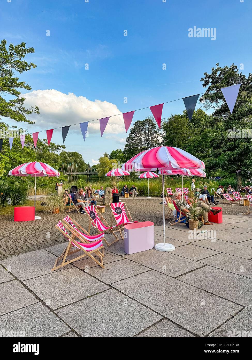 BERLIN, GERMANY - JULY 22, 2023: Sun loungers and umbrellas with the logo of the KULTUR SOMMER FESTIVAL in the Britzer Garten. Stock Photo
