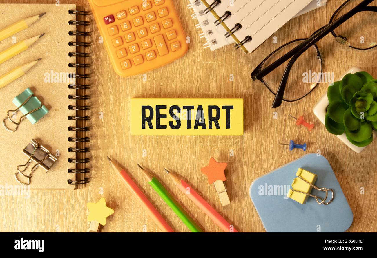 Restart and start symbol. The concept word Restart on wooden cubes. Beautiful orange table, orange background, copy space. Business restart and start Stock Photo